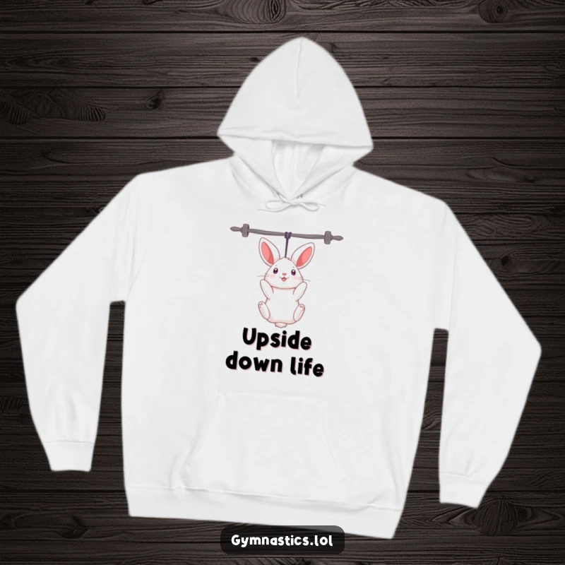 Funny rabbit hoodie depicting a curious rabbit hanging upside down from uneven bars, offering warmth and comedic athletic style.