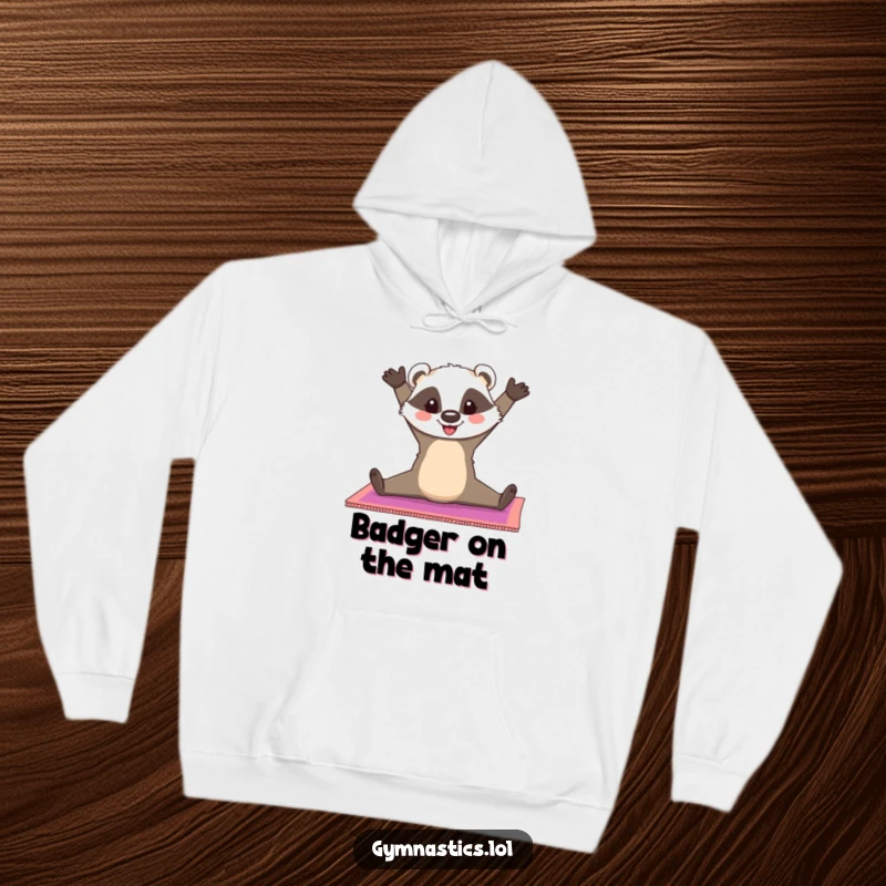 Funny Badger Hoodie: A cheerful badger does a split on a colorful gymnastics mat, offering cozy comfort and cheerful flexibility, a great funny gift.