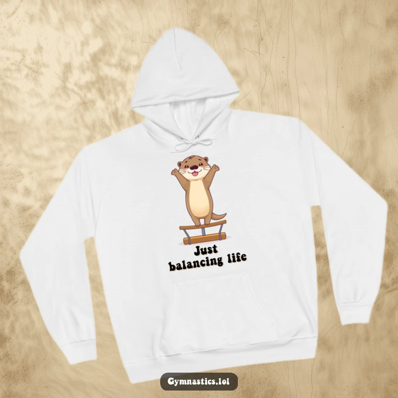 Funny hoodie with a smiling otter doing a graceful handstand on a balance beam, offering warmth and a splash of humorous skill.