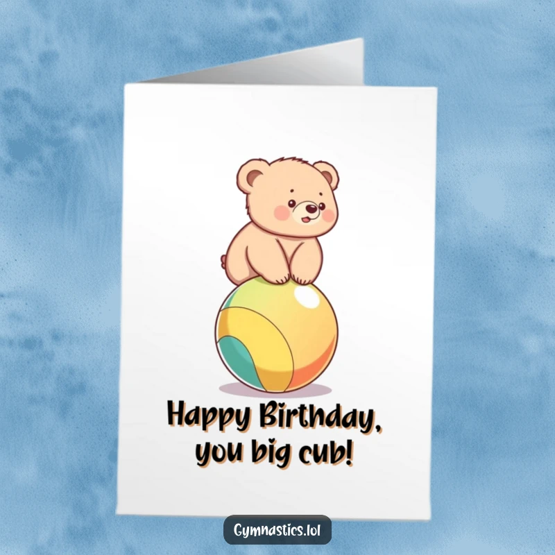 Funny free printable birthday card: A cute bear cub wobbling precariously on a colorful ball, wishing a happy birthday.